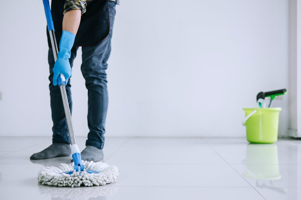 Husband housekeeping and cleaning concept, Happy young man in bl