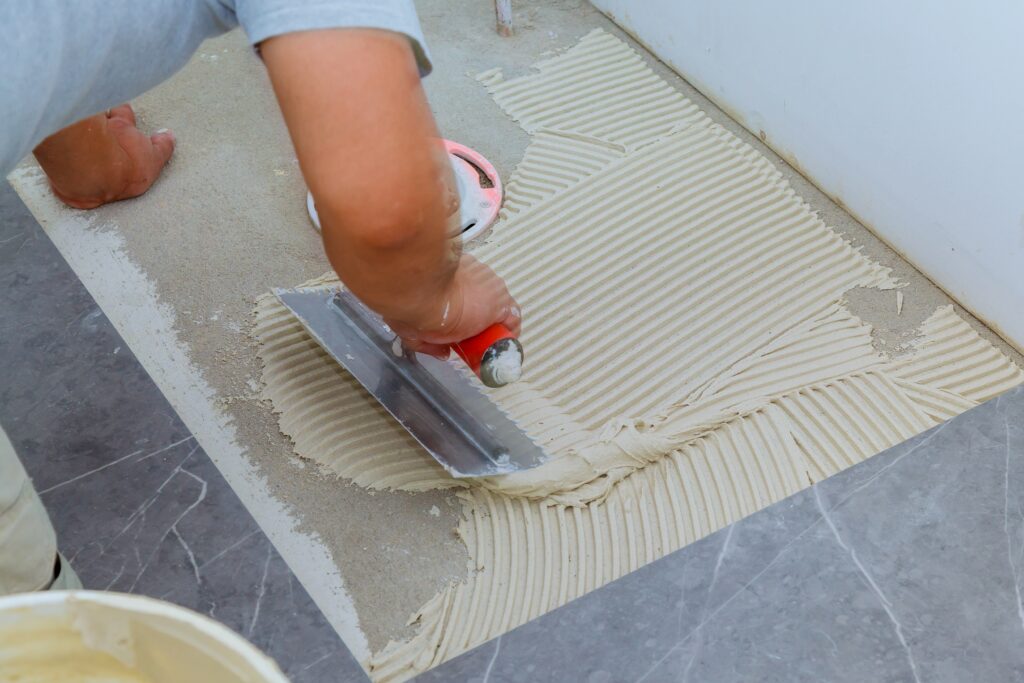 Ceramic tiles and tools for tiler. Floor tiles installation. Home improvement, renovation